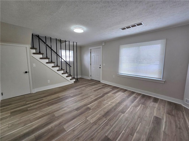 2381 Culver Rd, Irondequoit, NY 14609 - foyer featuring wood finished floors, stairs, and a textured ceiling