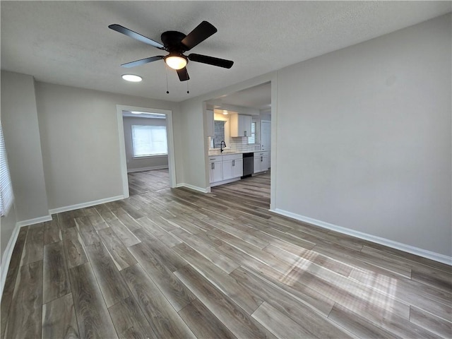 2381 Culver Rd, Irondequoit, NY 14609 - unfurnished living room featuring wood finished floors, ceiling fan, and a textured ceiling