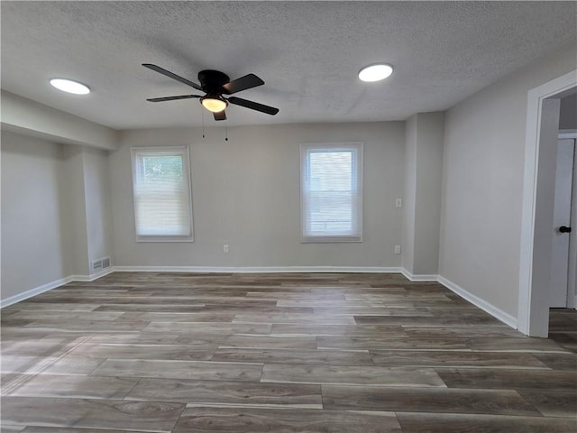 2381 Culver Rd, Irondequoit, NY 14609 - spare room featuring a textured ceiling, ceiling fan, healthy amount of natural light, and wood finished floors