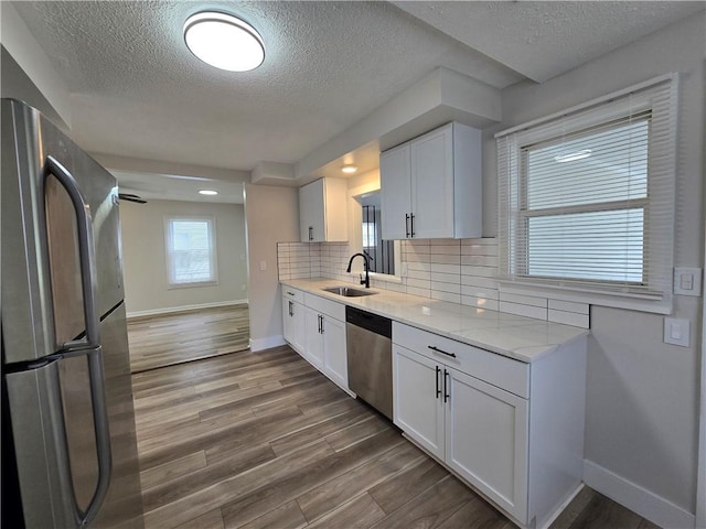 2381 Culver Rd, Irondequoit, NY 14609 - kitchen featuring stainless steel appliances, a textured ceiling, white cabinets, dark wood-style floors, and decorative backsplash
