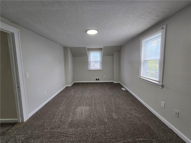 2381 Culver Rd, Irondequoit, NY 14609 - below grade area featuring dark colored carpet and a textured ceiling