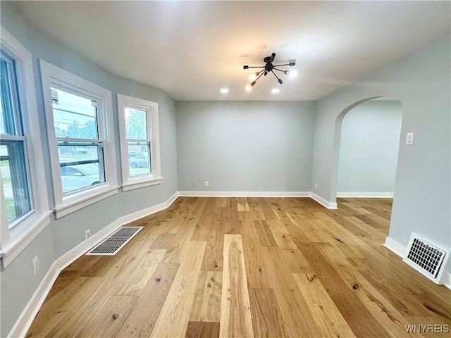 1433 Eggert Rd, Amherst, NY 14226 - spare room with arched walkways and light wood-type flooring