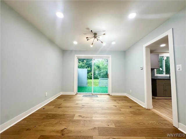 1433 Eggert Rd, Amherst, NY 14226 - unfurnished room with light wood-style floors, recessed lighting, and a chandelier
