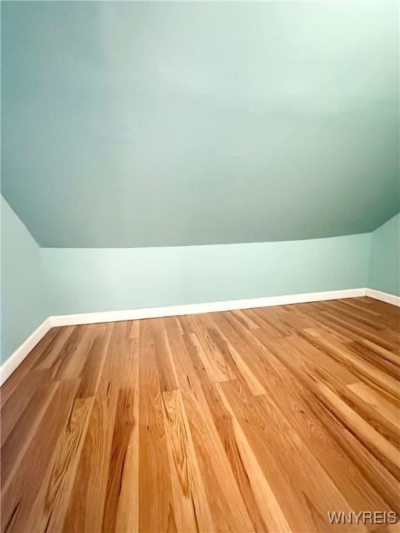 1433 Eggert Rd, Amherst, NY 14226 - additional living space featuring vaulted ceiling and wood finished floors