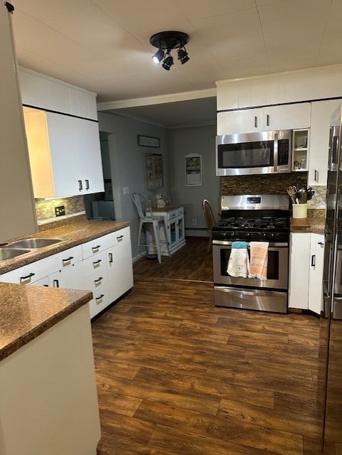 402 E Water St, Smethport Boro, PA 16749 - kitchen featuring appliances with stainless steel finishes, dark countertops, crown molding, backsplash, and white cabinets