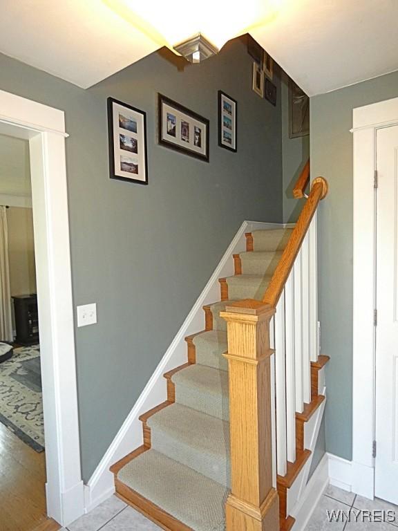 37 Woodmar Ter, West Seneca, NY 14224 - stairs with baseboards and tile patterned floors