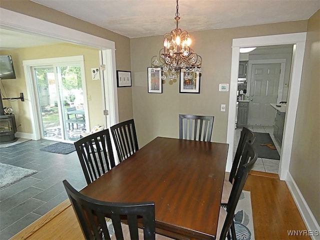 37 Woodmar Ter, West Seneca, NY 14224 - dining room featuring a chandelier, wood finished floors, and a wood stove