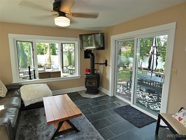 37 Woodmar Ter, West Seneca, NY 14224 - living area featuring dark tile patterned floors, a wood stove, and ceiling fan