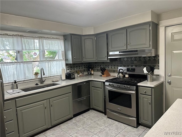 37 Woodmar Ter, West Seneca, NY 14224 - kitchen with stainless steel gas range, under cabinet range hood, dishwashing machine, gray cabinets, and light tile patterned flooring