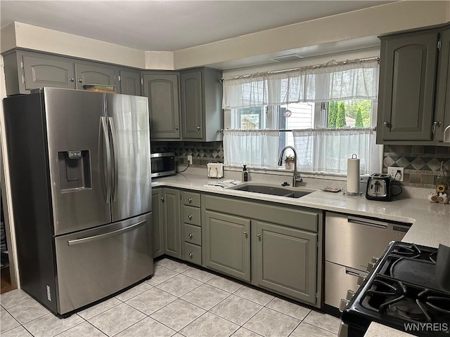 37 Woodmar Ter, West Seneca, NY 14224 - kitchen featuring appliances with stainless steel finishes, gray cabinetry, light tile patterned flooring, and backsplash