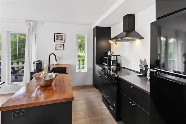 2064 County Highway 8, Roxbury, NY 12421 - kitchen with wall chimney range hood, black appliances, dark cabinets, and wood counters