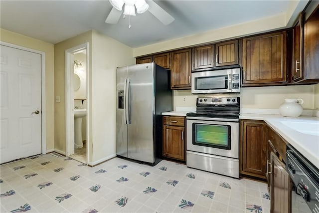 21 Spring Hl, Perinton, NY 14450 - kitchen with stainless steel appliances, light countertops, ceiling fan, and dark brown cabinets