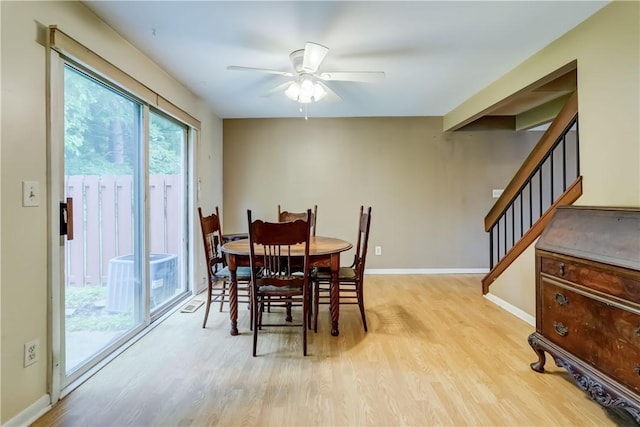 21 Spring Hl, Perinton, NY 14450 - dining space featuring light wood-style flooring, a ceiling fan, and stairway