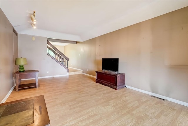 21 Spring Hl, Perinton, NY 14450 - unfurnished living room featuring stairway and wood finished floors