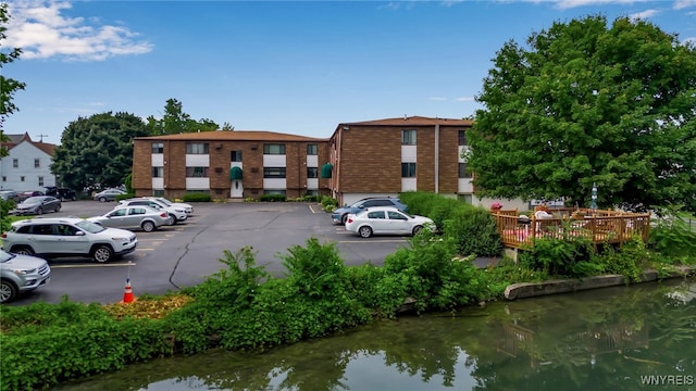 51 S 86th St Unit 10B, Niagara Falls, NY 14304 - view of building exterior with uncovered parking and a water view