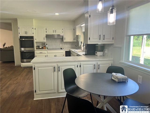 3420 Riverside Dr, Scio, NY 14895 - kitchen featuring stainless steel double oven, light countertops, white cabinetry, dark wood-type flooring, and a peninsula