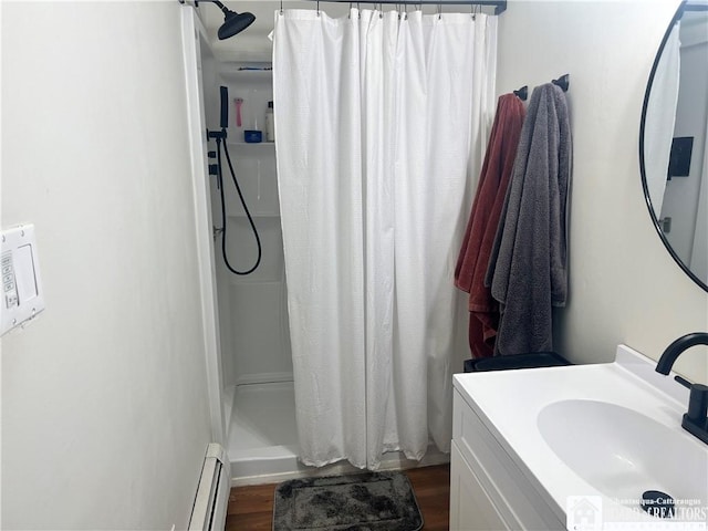 3420 Riverside Dr, Scio, NY 14895 - full bathroom with a baseboard radiator, curtained shower, vanity, and wood finished floors