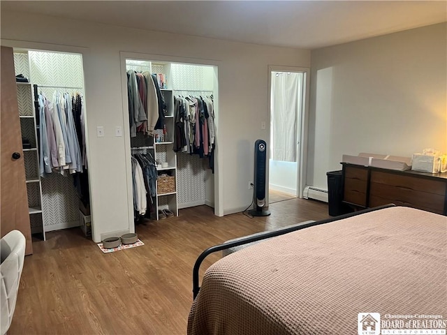 3420 Riverside Dr, Scio, NY 14895 - bedroom featuring wood finished floors, a baseboard heating unit, and a spacious closet
