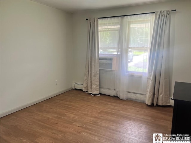 3420 Riverside Dr, Scio, NY 14895 - unfurnished room featuring a baseboard radiator, plenty of natural light, and wood finished floors