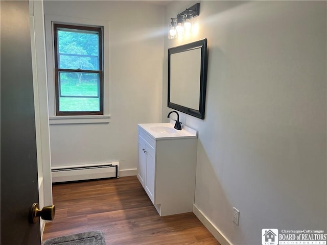 3420 Riverside Dr, Scio, NY 14895 - bathroom featuring a baseboard heating unit, vanity, and wood finished floors