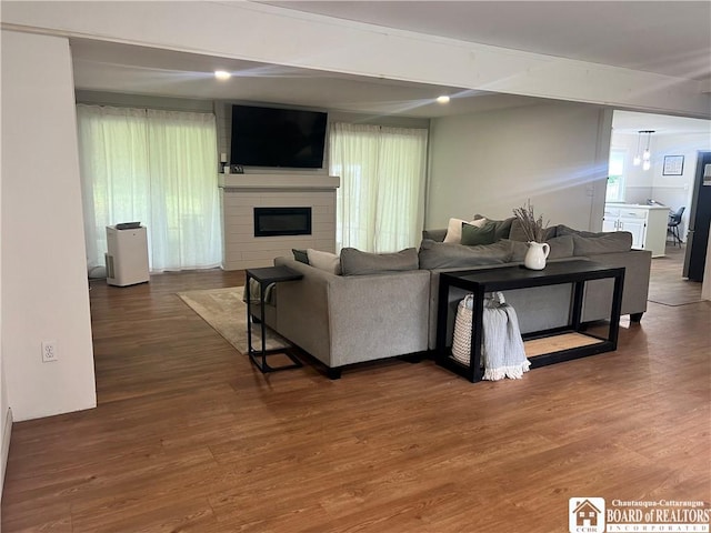 3420 Riverside Dr, Scio, NY 14895 - living area featuring wood finished floors and a large fireplace