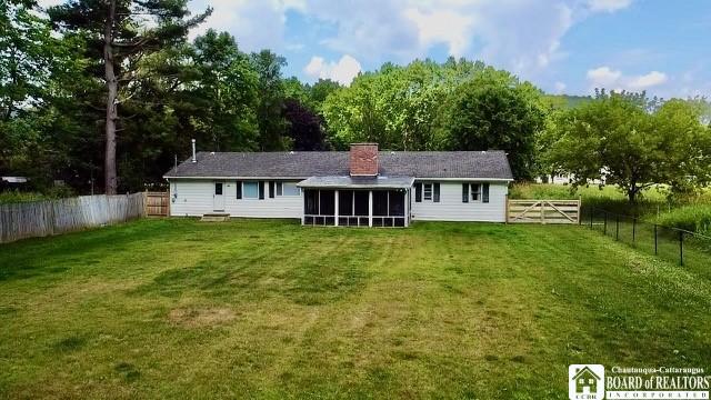 3420 Riverside Dr, Scio, NY 14895 - rear view of property with a sunroom, a fenced backyard, and a chimney