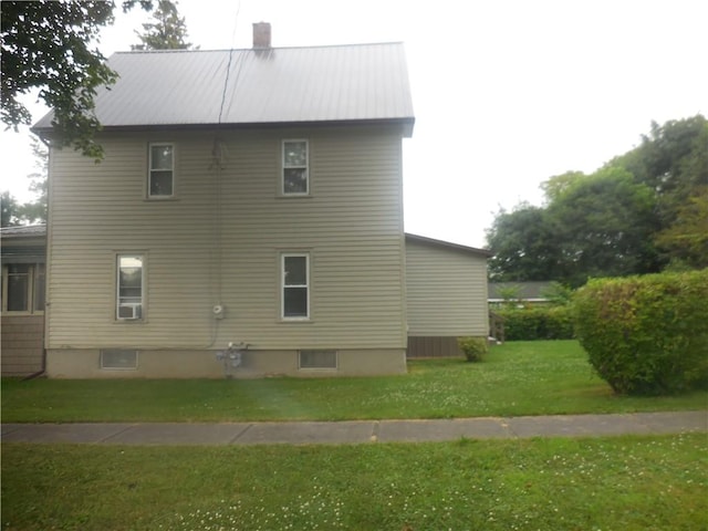 45 Olin Ave, Perry, NY 14530 - view of property exterior featuring a lawn, a chimney, and a metal roof