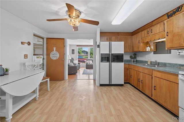 8500 Pools Brook Rd, Manlius, NY 13082 - kitchen featuring white refrigerator with ice dispenser, light wood-style flooring, a ceiling fan, and brown cabinets
