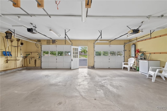 8500 Pools Brook Rd, Manlius, NY 13082 - garage with a garage door opener, refrigerator, and electric panel