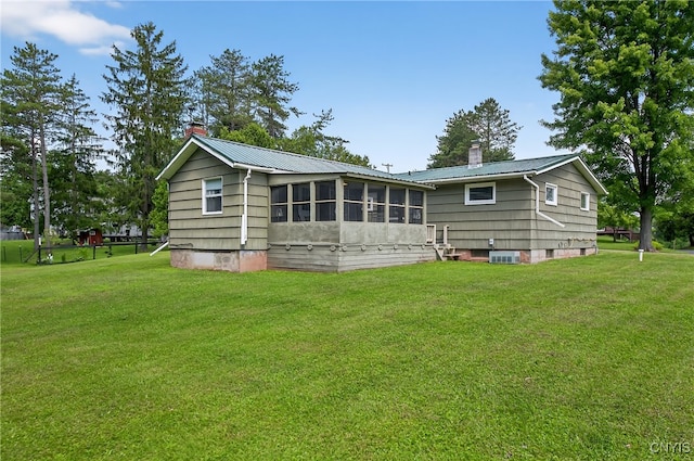 8500 Pools Brook Rd, Manlius, NY 13082 - back of property with a chimney, a sunroom, a yard, and a metal roof