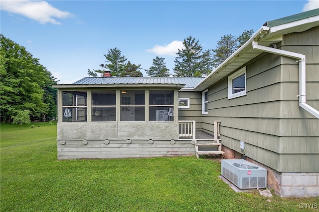 8500 Pools Brook Rd, Manlius, NY 13082 - back of house featuring a sunroom, a lawn, and a metal roof