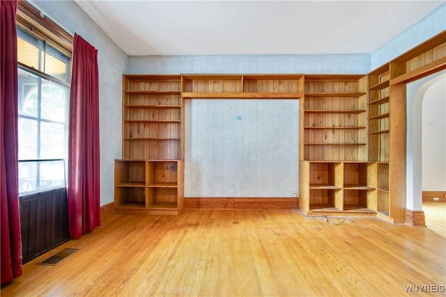 499 Breckenridge St, Buffalo, NY 14213 - unfurnished living room with wood finished floors, arched walkways, and built in features