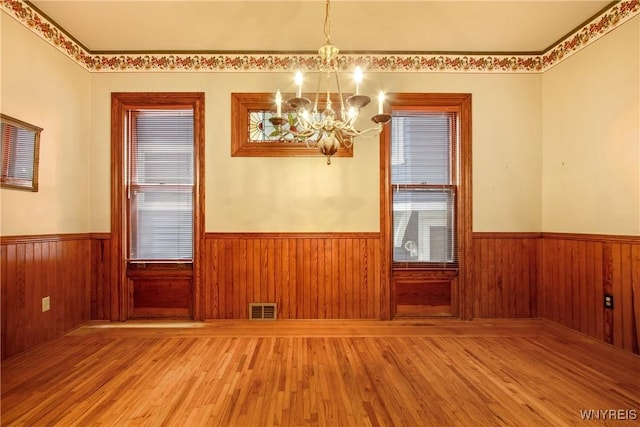 499 Breckenridge St, Buffalo, NY 14213 - unfurnished dining area with a chandelier, wainscoting, and wood finished floors