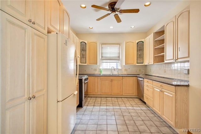 499 Breckenridge St, Buffalo, NY 14213 - kitchen featuring stainless steel appliances, light brown cabinetry, dark countertops, backsplash, and a ceiling fan
