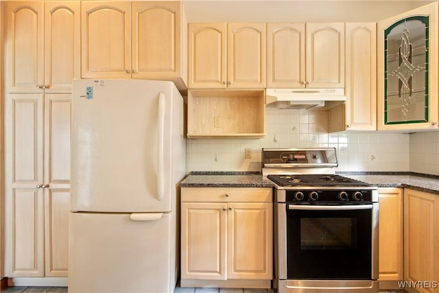 499 Breckenridge St, Buffalo, NY 14213 - kitchen featuring freestanding refrigerator, under cabinet range hood, gas stove, and dark stone countertops
