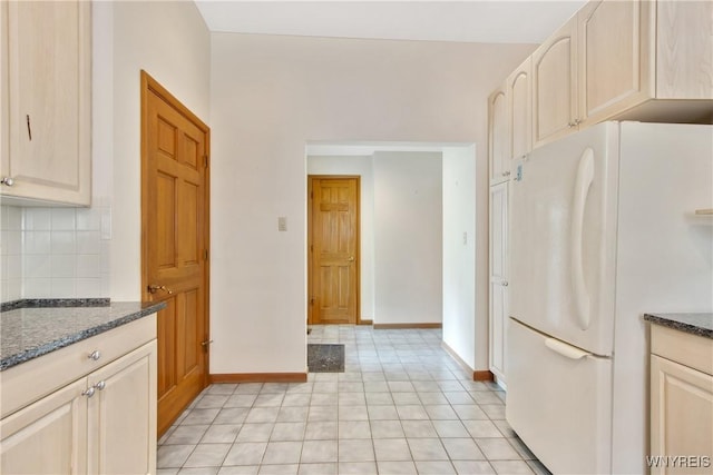 499 Breckenridge St, Buffalo, NY 14213 - kitchen with freestanding refrigerator, tasteful backsplash, dark stone countertops, and light tile patterned floors