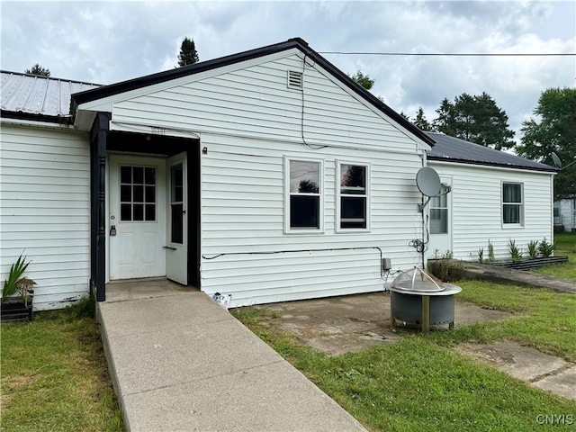 35381 State Route 3, Wilna, NY 13619 - view of front of house featuring an outdoor fire pit, a metal roof, and a front yard