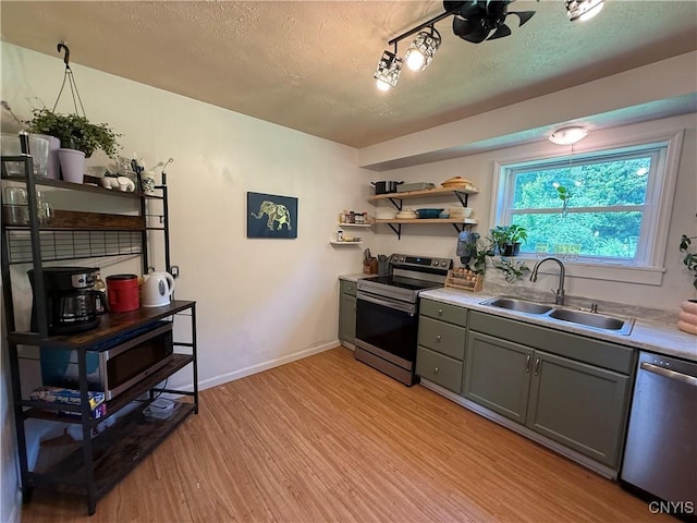 35381 State Route 3, Wilna, NY 13619 - kitchen featuring stainless steel appliances, light wood-type flooring, gray cabinets, a textured ceiling, and light countertops