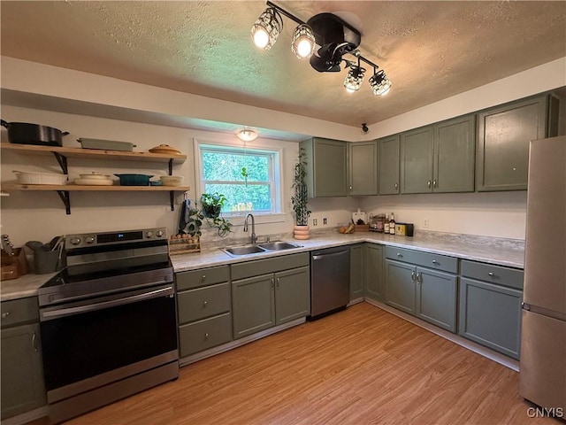 35381 State Route 3, Wilna, NY 13619 - kitchen featuring appliances with stainless steel finishes, a textured ceiling, gray cabinets, light wood-style floors, and light countertops