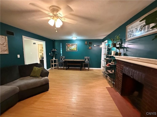 35381 State Route 3, Wilna, NY 13619 - living area with a ceiling fan, wood finished floors, and a fireplace