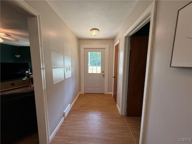 35381 State Route 3, Wilna, NY 13619 - doorway to outside featuring light wood-style flooring, a textured ceiling, and a ceiling fan
