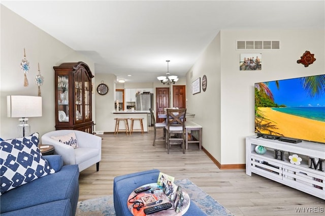 5861 Goodrich Rd Unit 6C, Clarence, NY 14032 - living room with a chandelier and light wood-type flooring