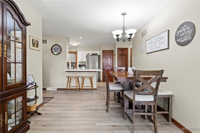 5861 Goodrich Rd Unit 6C, Clarence, NY 14032 - dining area featuring a chandelier, light wood-style flooring, and recessed lighting