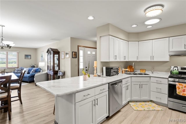 5861 Goodrich Rd Unit 6C, Clarence, NY 14032 - kitchen with appliances with stainless steel finishes, under cabinet range hood, a peninsula, white cabinetry, and recessed lighting