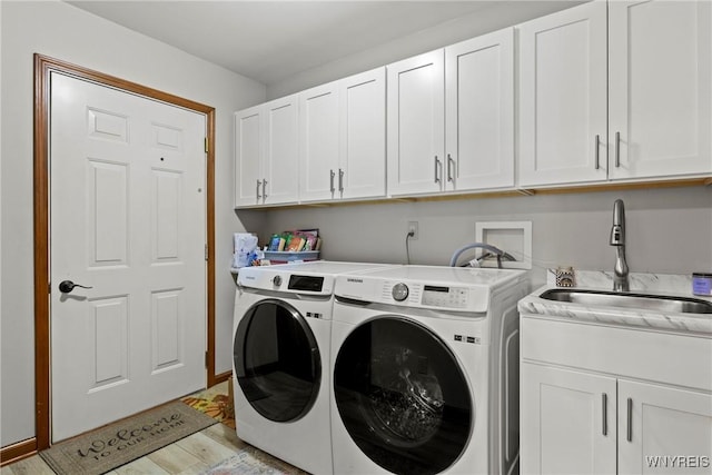 5861 Goodrich Rd Unit 6C, Clarence, NY 14032 - laundry room with cabinet space, washer and dryer, and light wood finished floors