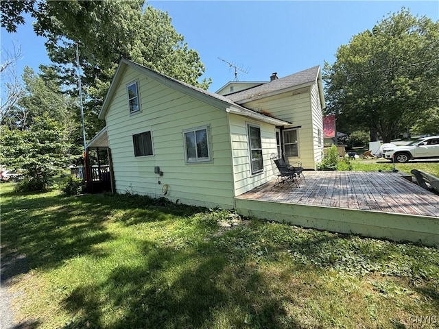 352 S Real St, Cape Vincent, NY 13618 - view of side of property featuring a yard, a deck, and a chimney