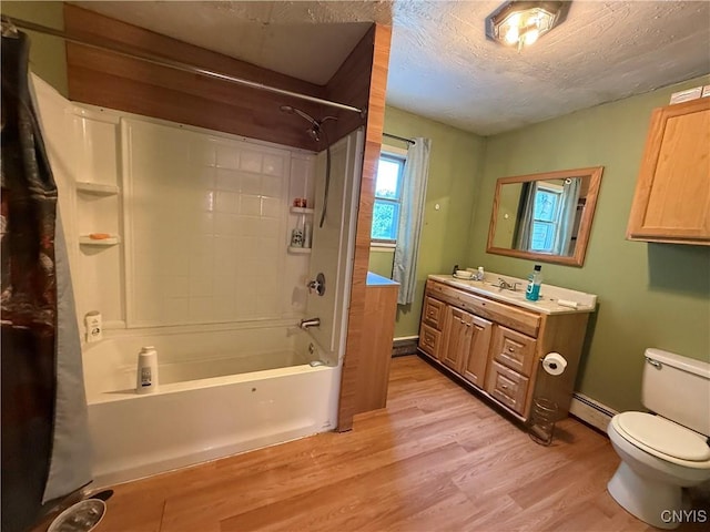 352 S Real St, Cape Vincent, NY 13618 - bathroom featuring baseboard heating, vanity, shower / bath combo with shower curtain, wood finished floors, and a textured ceiling