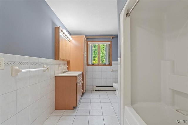 6924 Todd Way, Salina, NY 13088 - bathroom featuring tile walls, tile patterned floors, a baseboard heating unit, vanity, and a wainscoted wall