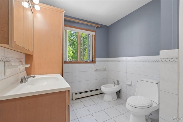 6924 Todd Way, Salina, NY 13088 - bathroom with a baseboard radiator, tile patterned flooring, a bidet, tile walls, and wainscoting