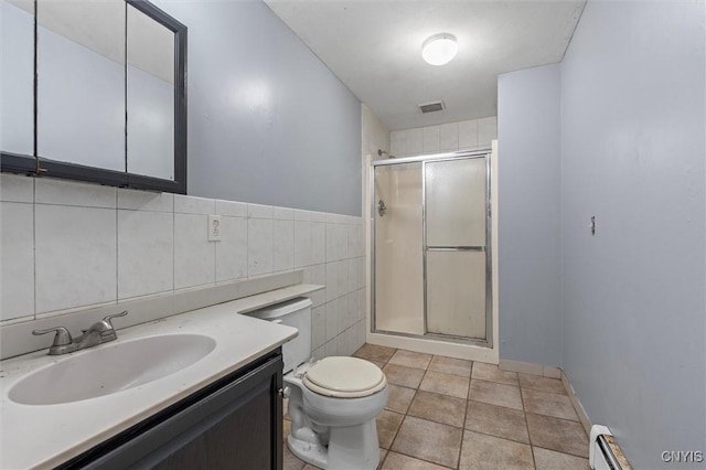 6924 Todd Way, Salina, NY 13088 - full bath with a shower stall, vanity, tile walls, tile patterned flooring, and baseboard heating